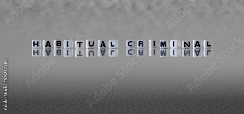 habitual criminal word or concept represented by black and white letter cubes on a grey horizon background stretching to infinity