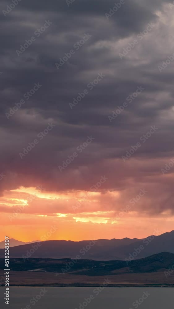 Timelapse of sunset glowing behind dark clouds as storm moves in. Timelapse of sunset glowing behind dark clouds as storm moves in.