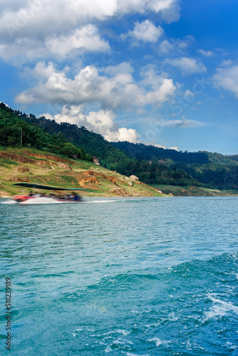 long tail boat is motion blur with Green Mountain at Khun Dan Prakarn Chon Dam Nakhon Nayok Thailand. © zodar