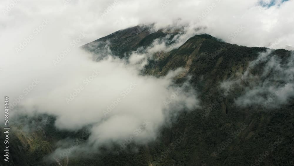 Active Tungurahua Volcano Covered In Dense Cloudscape Within The Bounds Of Baños, Ecuador- Cordillera Oriental. Drone Vertical Shot Active Tungurahua Volcano Covered In Dense Cloudscape Within The Bounds Of Baños, Ecuador- Cordillera Oriental. Drone Vertical Shot