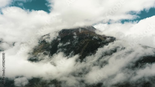 Panorama Of Tungurahua Stratovolcano Covered With Clouds From Baños In Ecuador. - wide photo