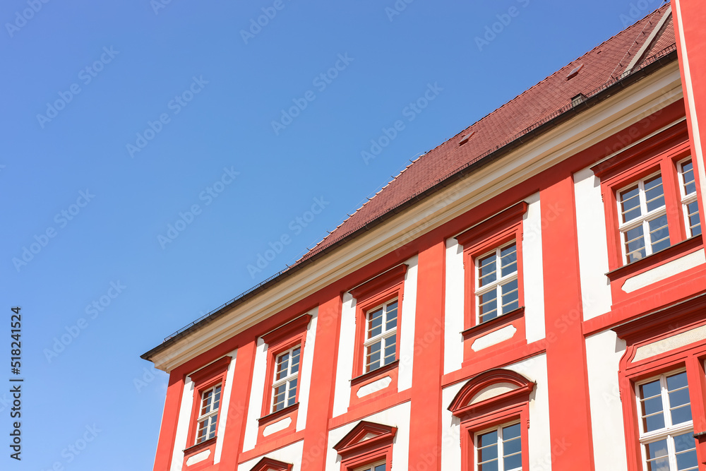 Beautiful building with red roof against blue sky, low angle view Beautiful building with red roof against blue sky, low angle view