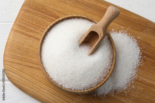 Granulated sugar on white table, top view