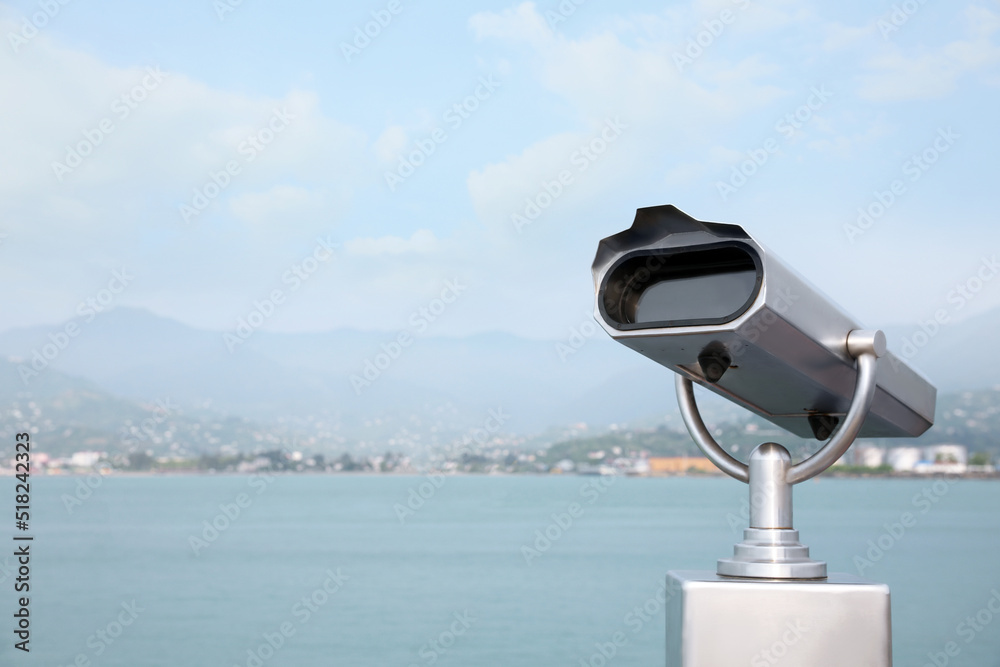 Metal tower viewer installed near sea, space for text. Mounted binoculars Metal tower viewer installed near sea, space for text. Mounted binoculars