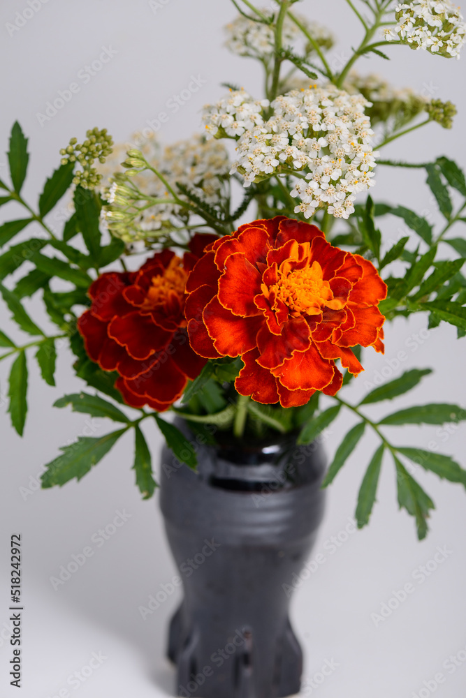 a bouquet of flowers in a black vase
