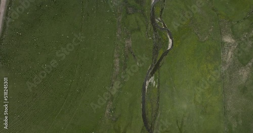 Top View Of Vast Pasture Land With Flowing River At Ktsia-Tabatskuri Managed Reserve In Samtskhe-Javakheti Region Of Georgia. Aerial Drone Shot photo