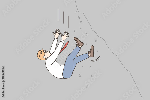 Businessman falling from cliff