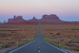 Scenic Road in the Dry Desert with Red Rocky Mountains in Background. Sunrise Sky. Forrest Gump Point in Oljato-Monument Valley, Utah, United States.