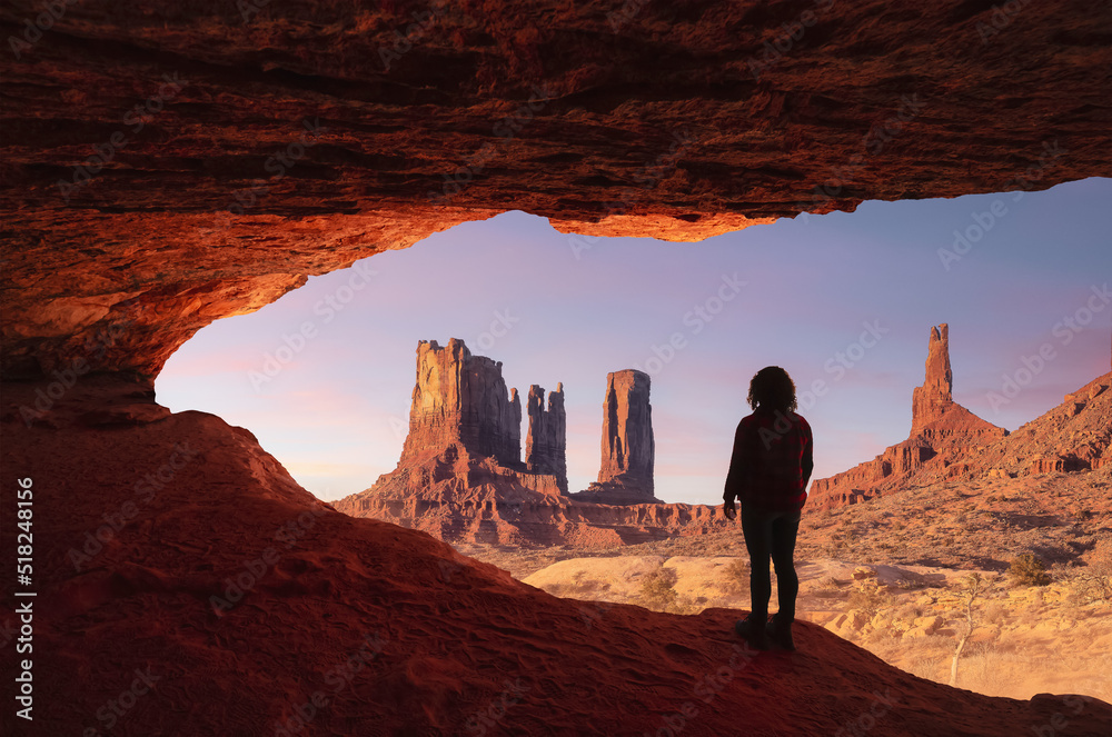 Adventurous Woman standing in a cave with rocky mountains in background. Sunset or Sunrise Sky. Adventure Art Composite. Landscape from United States of America.