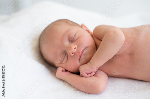 Newborn sleeping soundly and peacefully on white blanket. Birth baby - happiness for family. New worries and style life. Concept of child care, feeling safe, parent love.