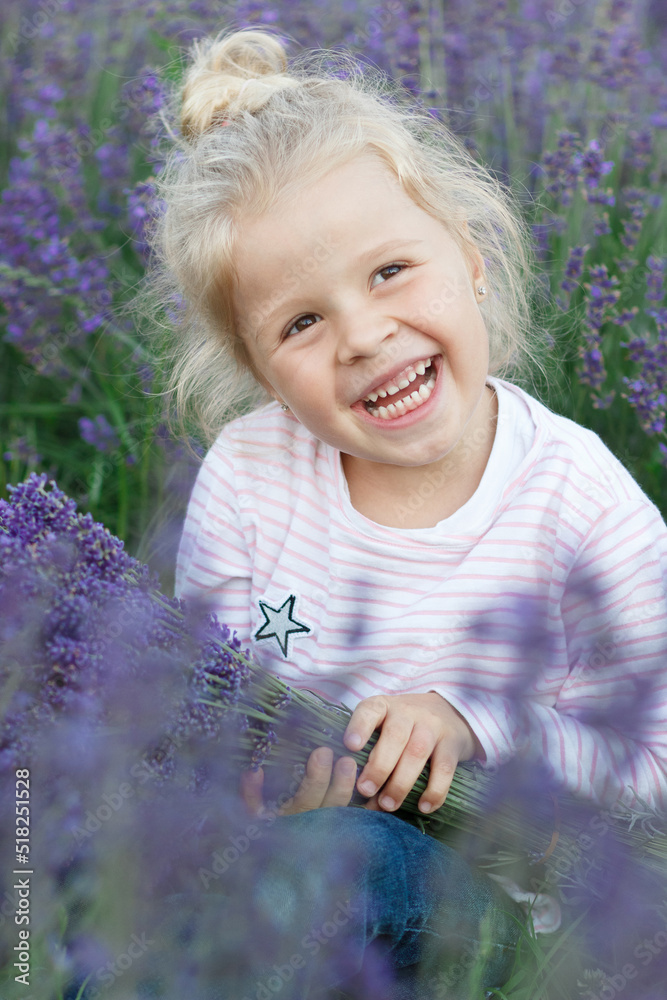 Little beautiful girl with a bouquet of lavender flowers, outdoors Little beautiful girl with a bouquet of lavender flowers, outdoors
