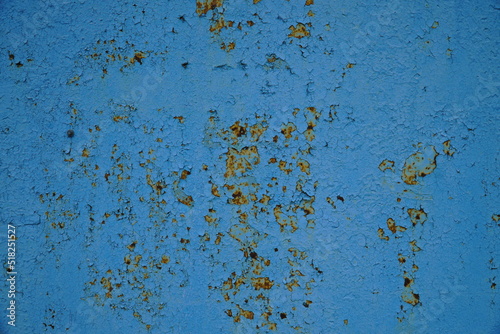Metal rusty surface with shabby background paint. Texture blue cracked paint on an iron sheet. Metal Corrosion