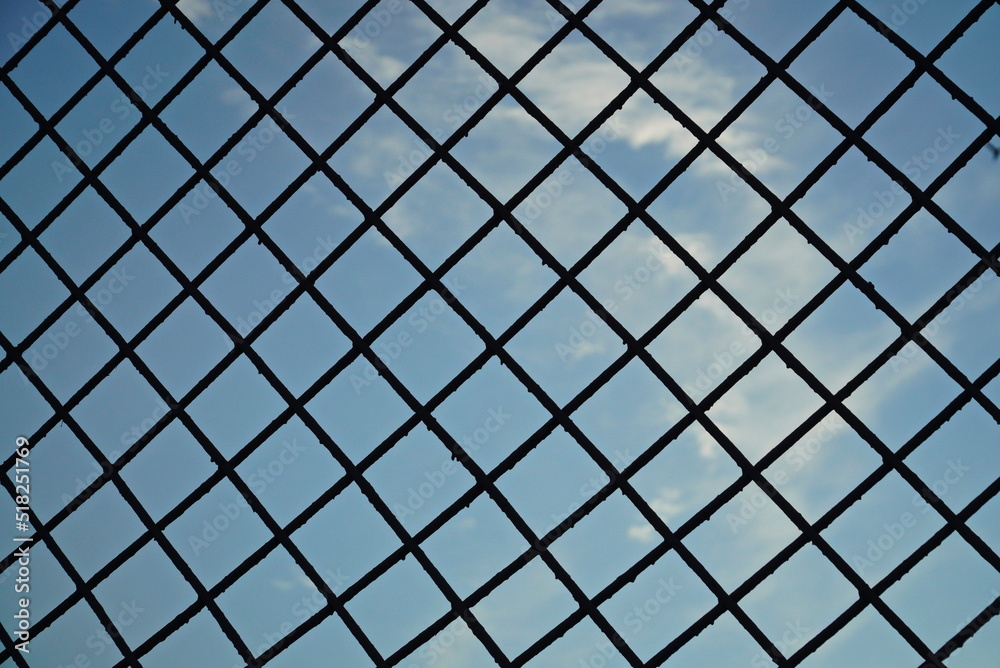 Photo of a clear sky through a metal grille Photo of a clear sky through a metal grille