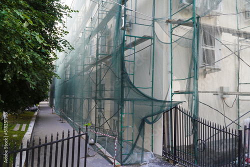 The facade of the building is closed with a grid  the building is under reconstruction