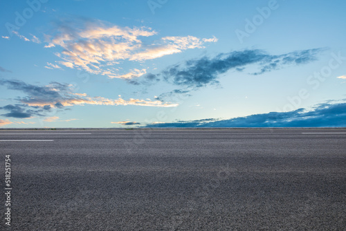 Empty asphalt road and sky clouds at sunrise. © ABCDstock