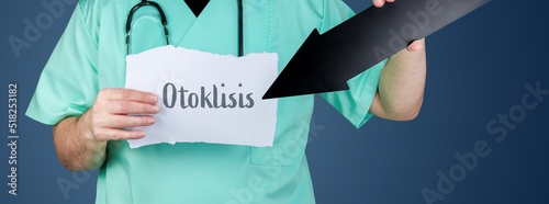 Otoklisis. Arzt hält Zettel und zeigt mit Pfeil auf medizinischen Begriff. photo