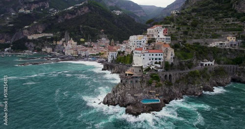 Historic Town Of Amalfi Nestled On Steep Cliffs In Campania, Italy. Aerial Drone Shot photo