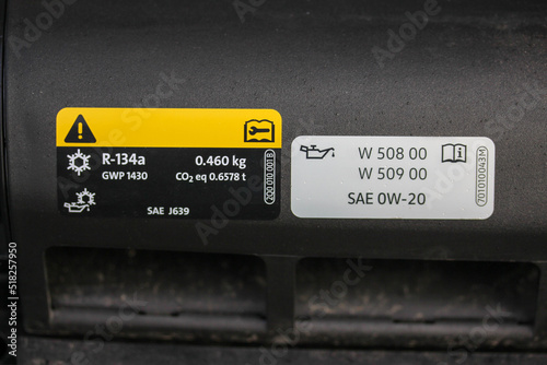 Obraz na płótnie Air conditioning and oil warning labels under the hood of a new vehicle w salonie