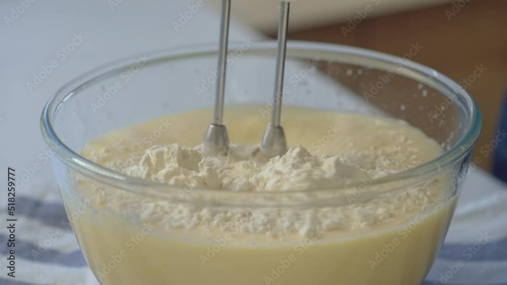 woman in the kitchen mixing ingredients and flour for cake woman in the kitchen mixing ingredients and flour for cake