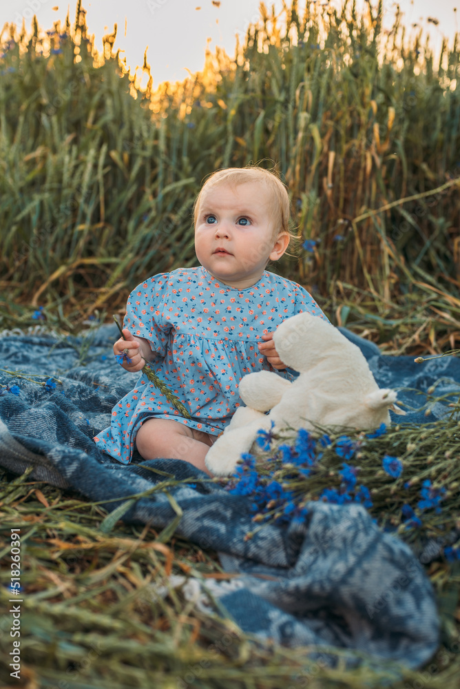 portrait of happy cute little girl on a picnic blanket outdoors portrait of happy cute little girl on a picnic blanket outdoors