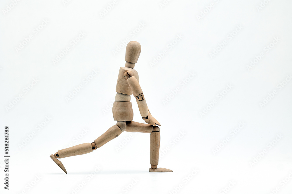 a wooden mannequin doing exercises on white background. warm up exercise a wooden mannequin doing exercises on white background. warm up exercise