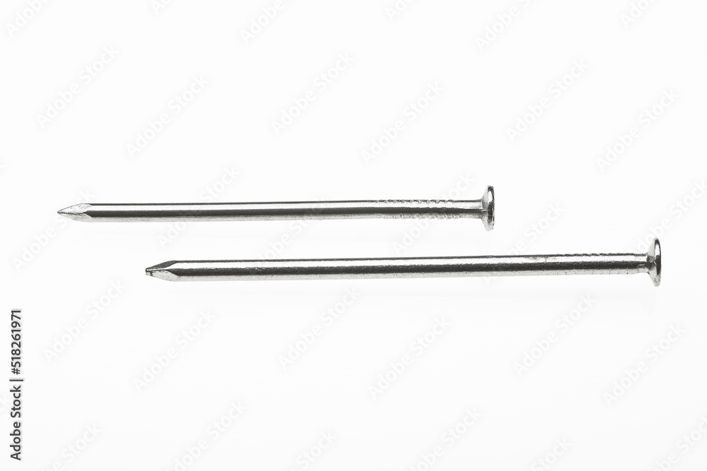 two nails on a white surface two nails on a white surface