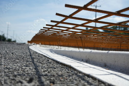 Reinforced concrete road construction and the process of placing the steel grating to prevent cracks (blurred image)