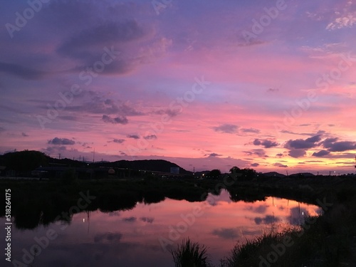 Beautiful sky with clouds and river at sunset.  © loveallyson