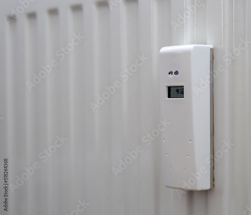 White heat meter hanging on the radiator in Poland photo