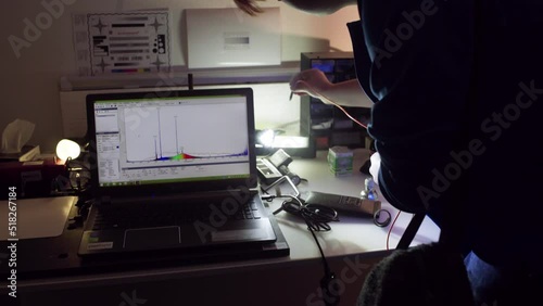 Using a photometer to measure the brightness of a single LED lightbulb photo