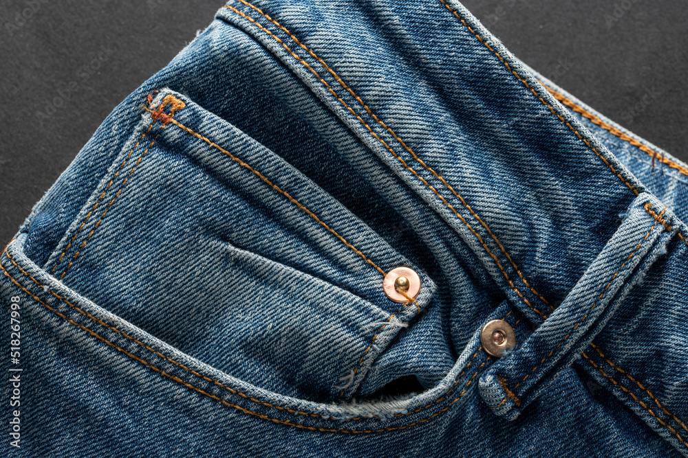 Ecological blue jeans on dark background. Eco friendly clothing concept Ecological blue jeans on dark background. Eco friendly clothing concept