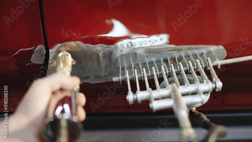 Obraz na płótnie Repairing car body The mechanic repair the car
