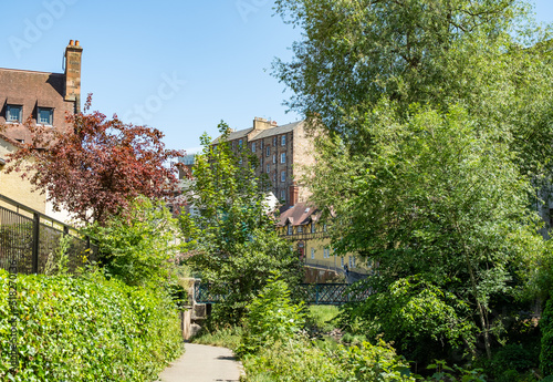 Footpath along the Water of Leith towards the district of Dean in the city of Edinburgh on a bright and sunny day