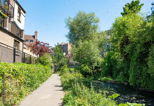 Footpath along the Water of Leith towards the district of Dean in the city of Edinburgh on a bright and sunny day