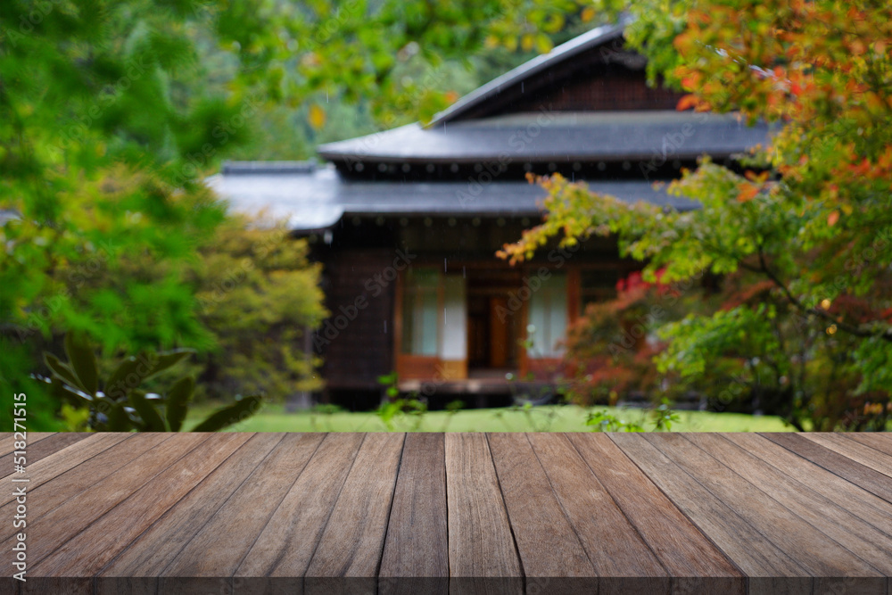 Wooden table top with blurred garden and japan house. Wooden table top with blurred garden and japan house.