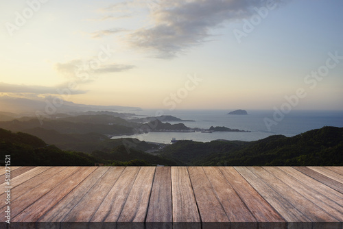 Wooden table top with sea view sunset time.