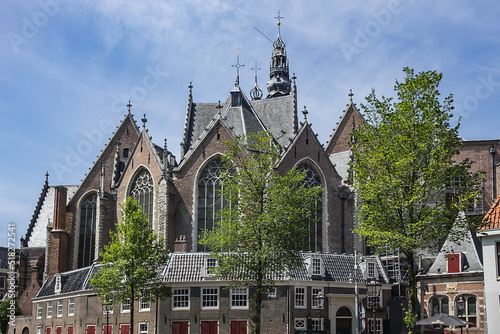 Amsterdam Old Church (Oude Kerk), oldest parish church, founded in 1213. Oude Kerk stands in Amsterdam De Wallen district on Old Church's Square (Oudekerksplein). Amsterdam, The Netherlands. photo