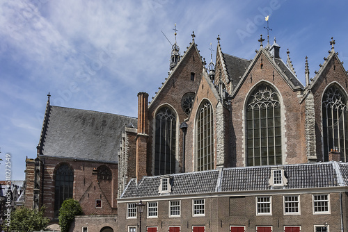 Amsterdam Old Church (Oude Kerk), oldest parish church, founded in 1213. Oude Kerk stands in Amsterdam De Wallen district on Old Church's Square (Oudekerksplein). Amsterdam, The Netherlands. photo