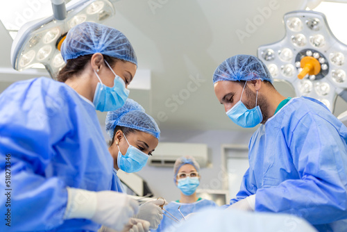A surgeon s team in uniform performs an operation on a patient at a cardiac surgery clinic. Modern medicine  a professional team of surgeons  health.