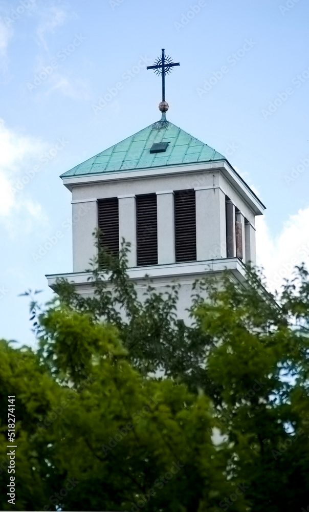 Old catholic church tower with cross.