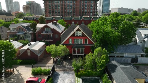 Colorful red A-frame home in urban city in USA. Aerial dolly forward. photo