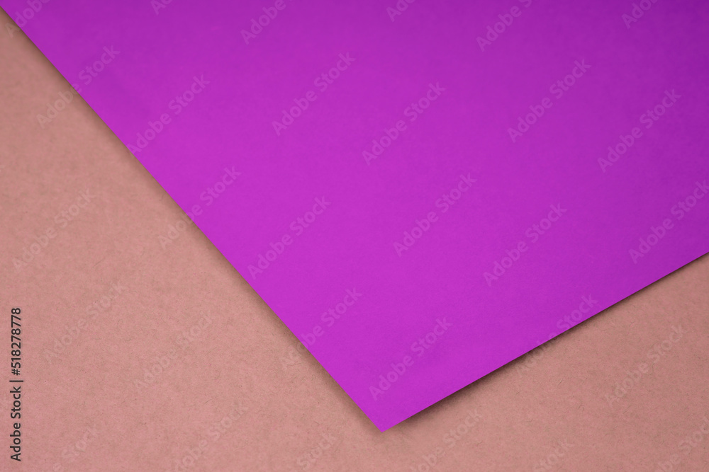 Plain pink purple paper sheet lying on peach brown textured Background like an open book from top angle Plain pink purple paper sheet lying on peach brown textured Background like an open book from top angle