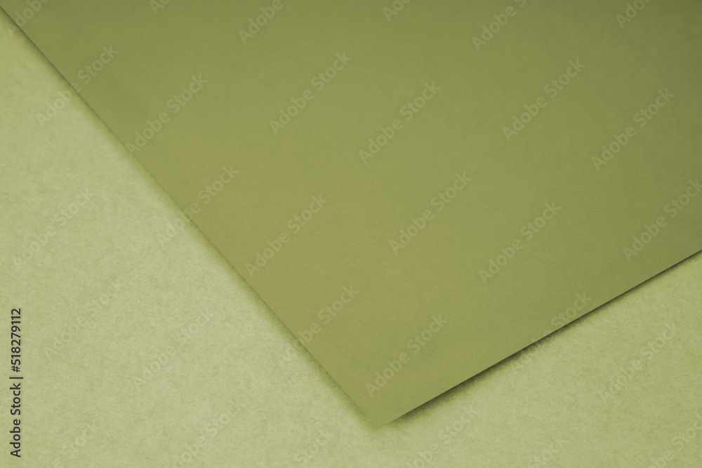 Plain green paper sheet lying on brown textured Background like an open book from top angle Plain green paper sheet lying on brown textured Background like an open book from top angle