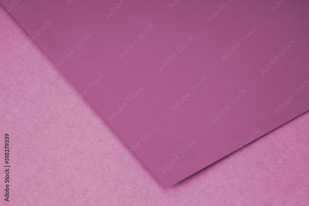 Plain pink paper sheet lying on textured Background like an open book from top angle Plain pink paper sheet lying on textured Background like an open book from top angle
