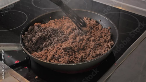 Chef stir and fry minced meat in a frying pan