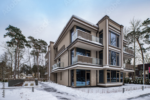 Modern exterior of new luxury residential building at winter.
