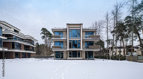 Modern exterior of new luxury residential building at winter.