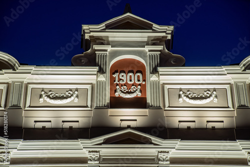 Modern illuminated residential building. Detail of exterior.