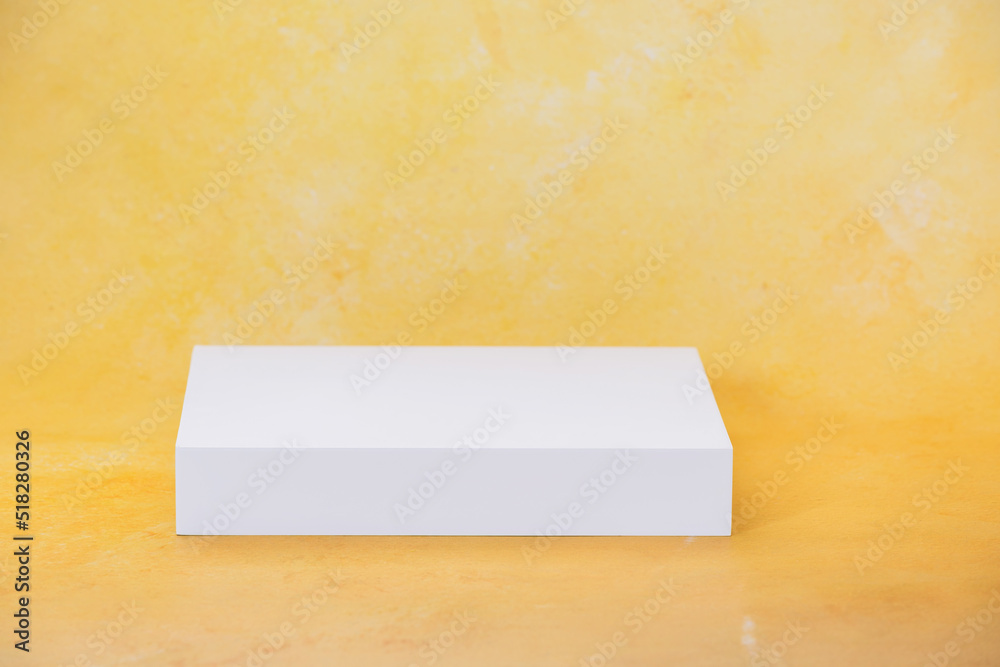Yellow color abstract background and white geometric podium for product presentation, selective focus, copy space Yellow color abstract background and white geometric podium for product presentation, selective focus, copy space