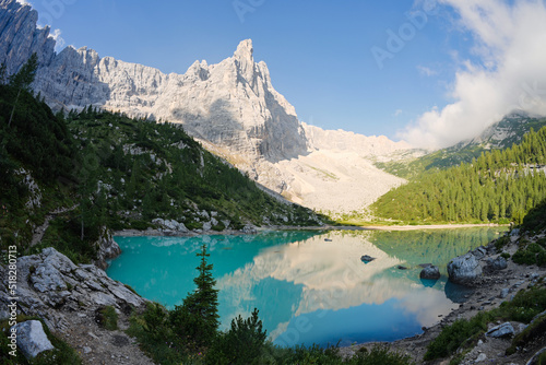 Fototapeta Naklejka Na Ścianę i Meble -  Stunning view of Lake Sorapis with its turquoise waters and surrounded by beautiful rocky mountains.  Lake Sorapis is one of the most beautiful excursions in the Dolomites, Italy.